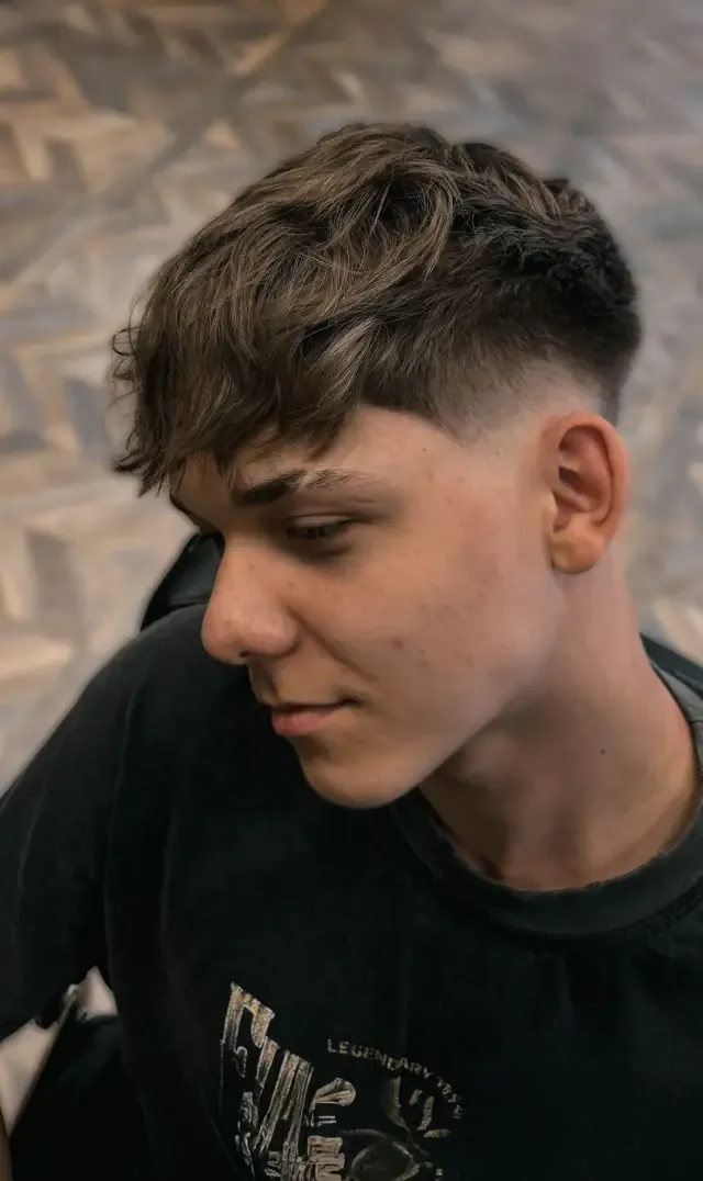 Young client in the chair at Gentlemen Barber Shop Krakow in Kazimierz